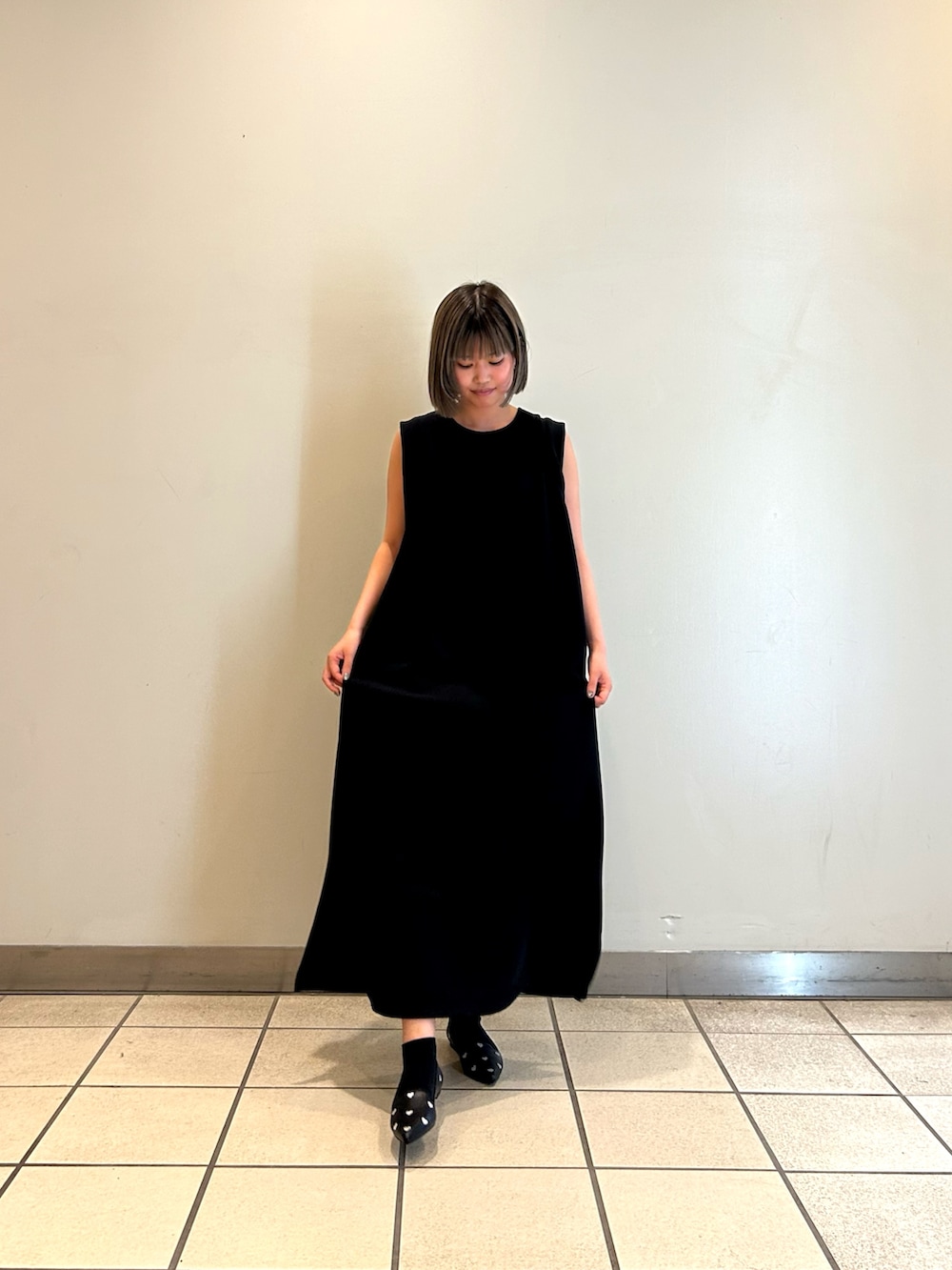 ブラック系のワンピース、ブラック系のパンプスを着用したレディースの秋コーディネートの3枚目の写真