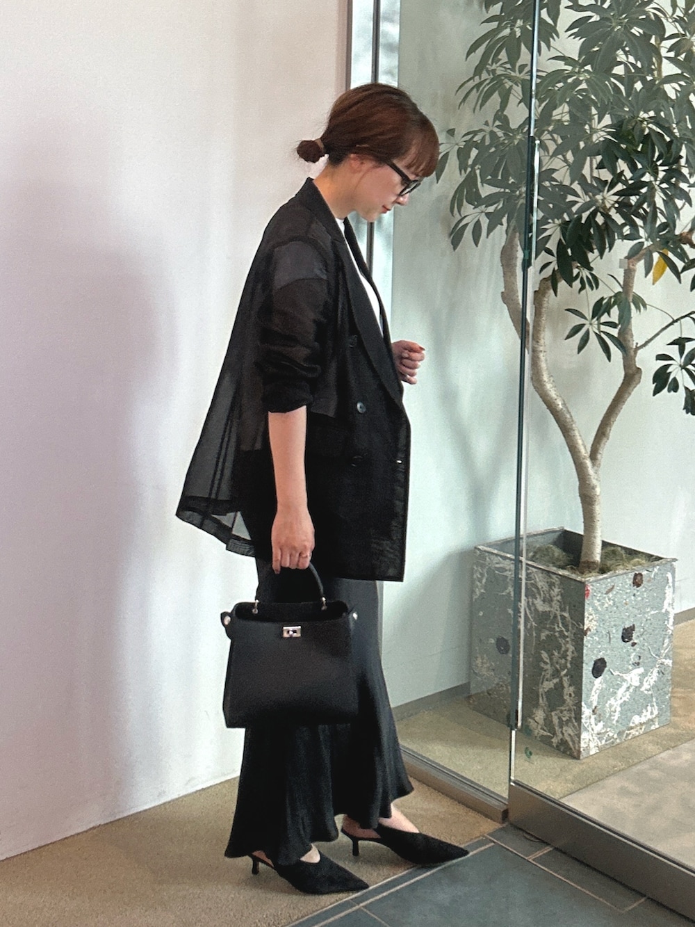 ブラック系のパンプス、ブラック系のテーラードジャケットを着用したレディースの春コーディネートの2枚目の写真