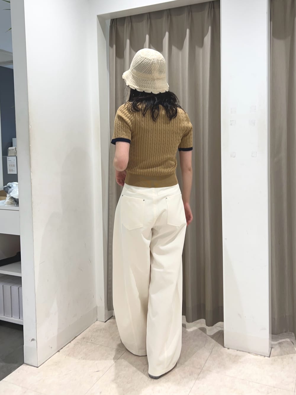 ベージュ系のニット/セーター、ホワイト系のその他パンツ、ホワイト系のハットを着用したレディースの夏コーディネートの2枚目の写真