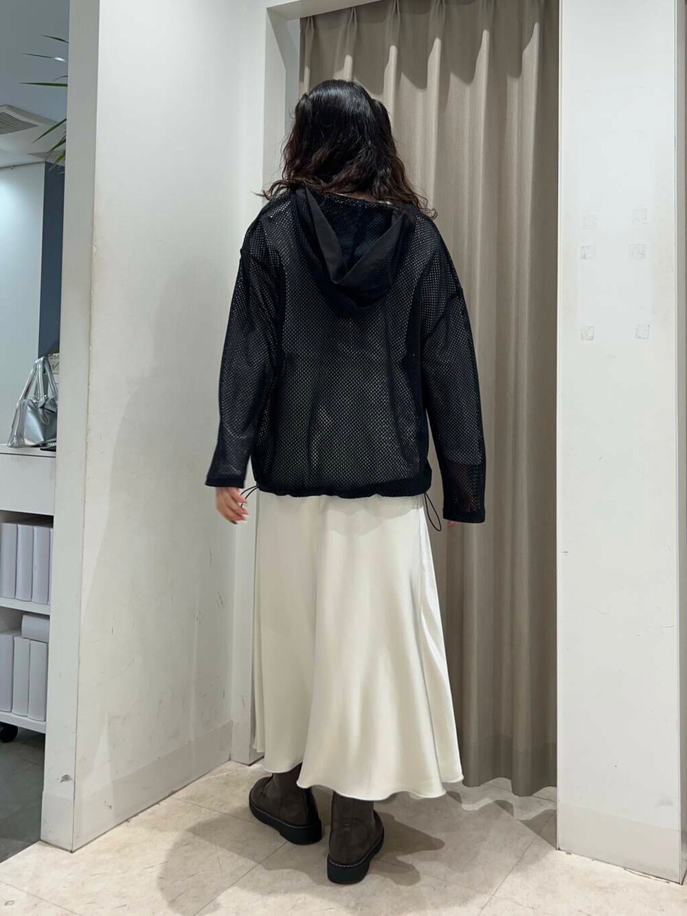 ホワイト系のスカート、ホワイト系のTシャツ/カットソー、ブラック系のその他トップスを着用したレディースの春コーディネートの2枚目の写真