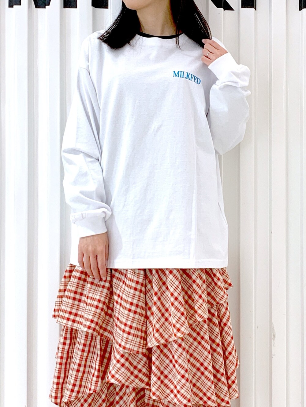 ホワイト系のTシャツ/カットソー、レッド系のスカート、レッド系のキャップを着用したレディースの冬コーディネートの7枚目の写真