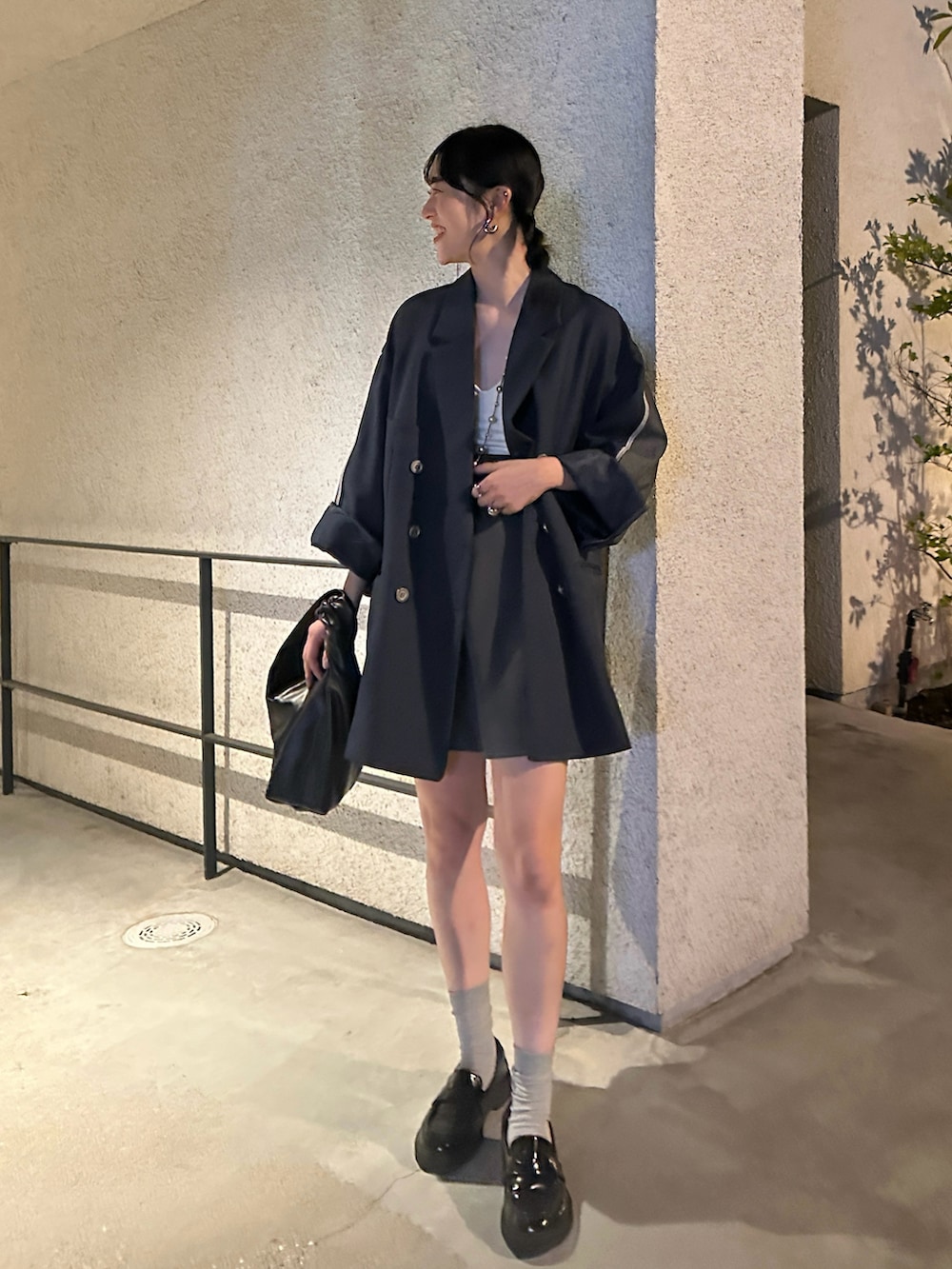 グレー系のその他パンツ、ブラック系のシューズ、ブラック系のハンドバッグを着用したレディースの秋コーディネートの2枚目の写真