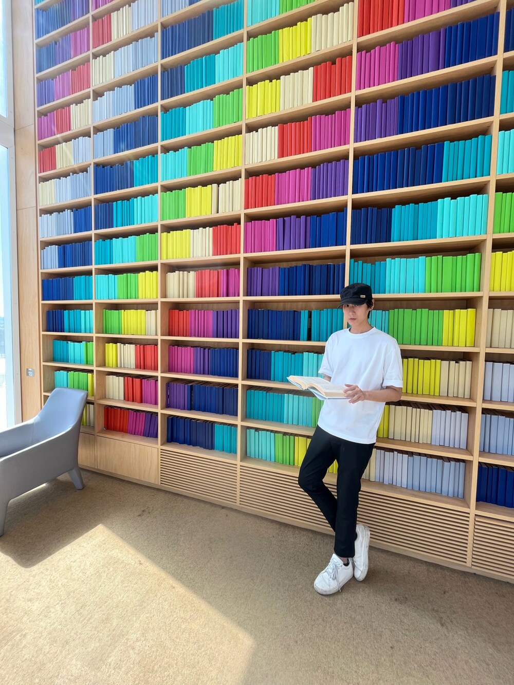 ブラック系のチノパンツ、ホワイト系のTシャツ/カットソー、ブラック系のキャップを着用したメンズの春コーディネートの2枚目の写真