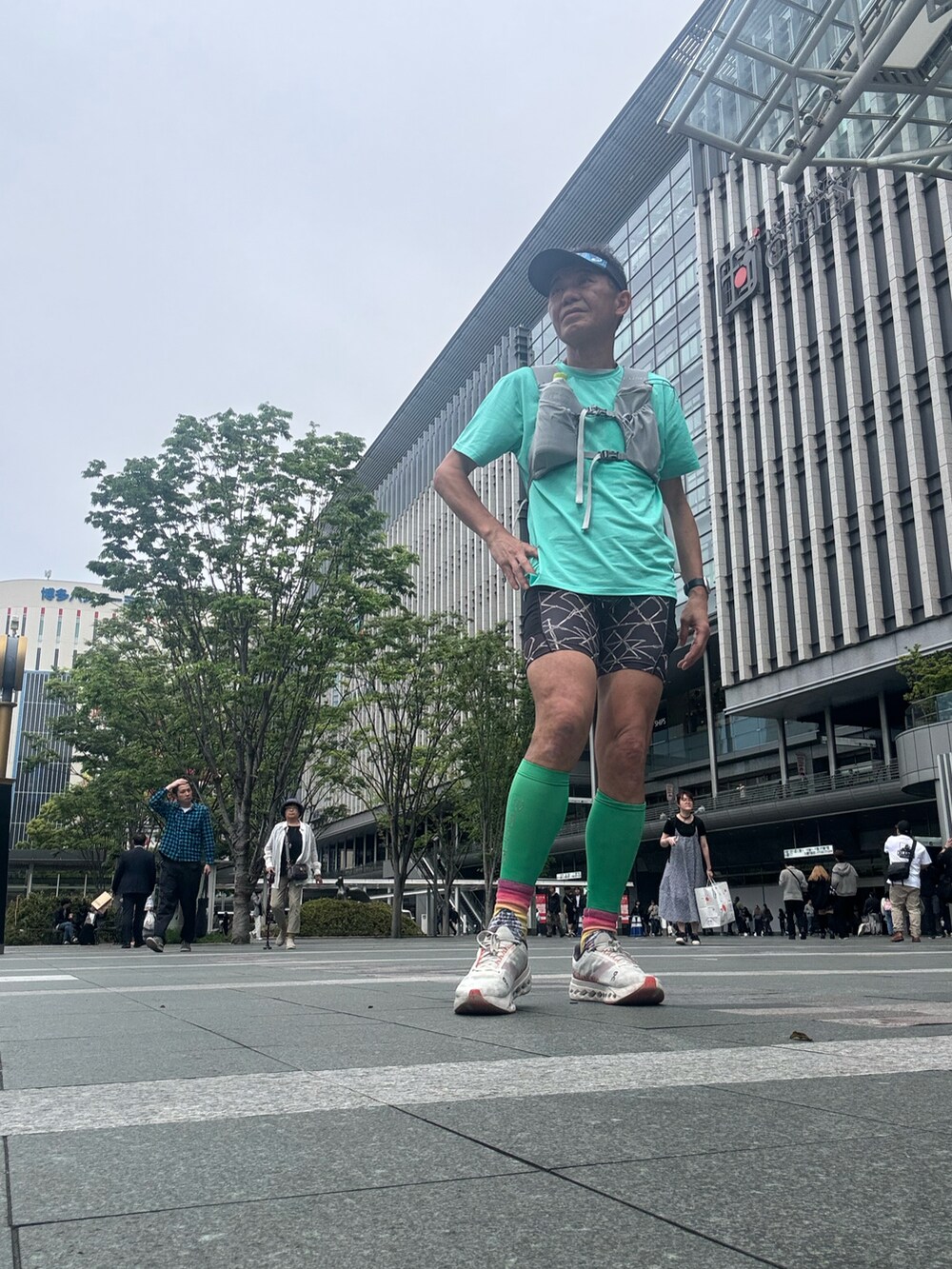 グリーン系のTシャツ/カットソー、ホワイト系のスニーカー、ブラック系のレギンス/スパッツを着用したメンズの春コーディネートの5枚目の写真