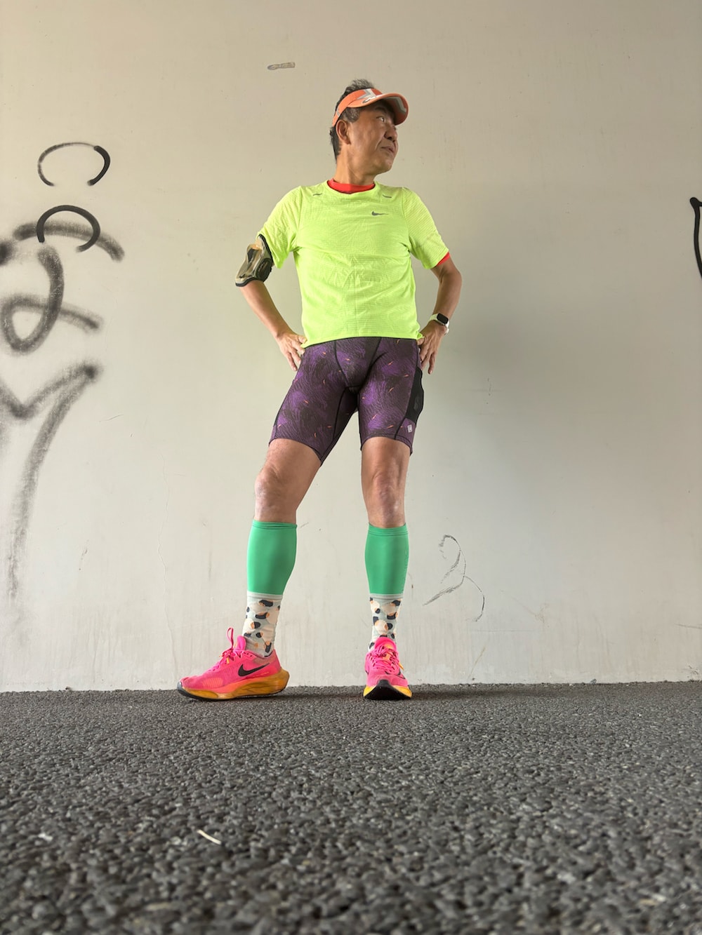 グリーン系のTシャツ/カットソー、ピンク系のスニーカー、パープル系のレギンス/スパッツを着用したメンズの冬コーディネートの2枚目の写真