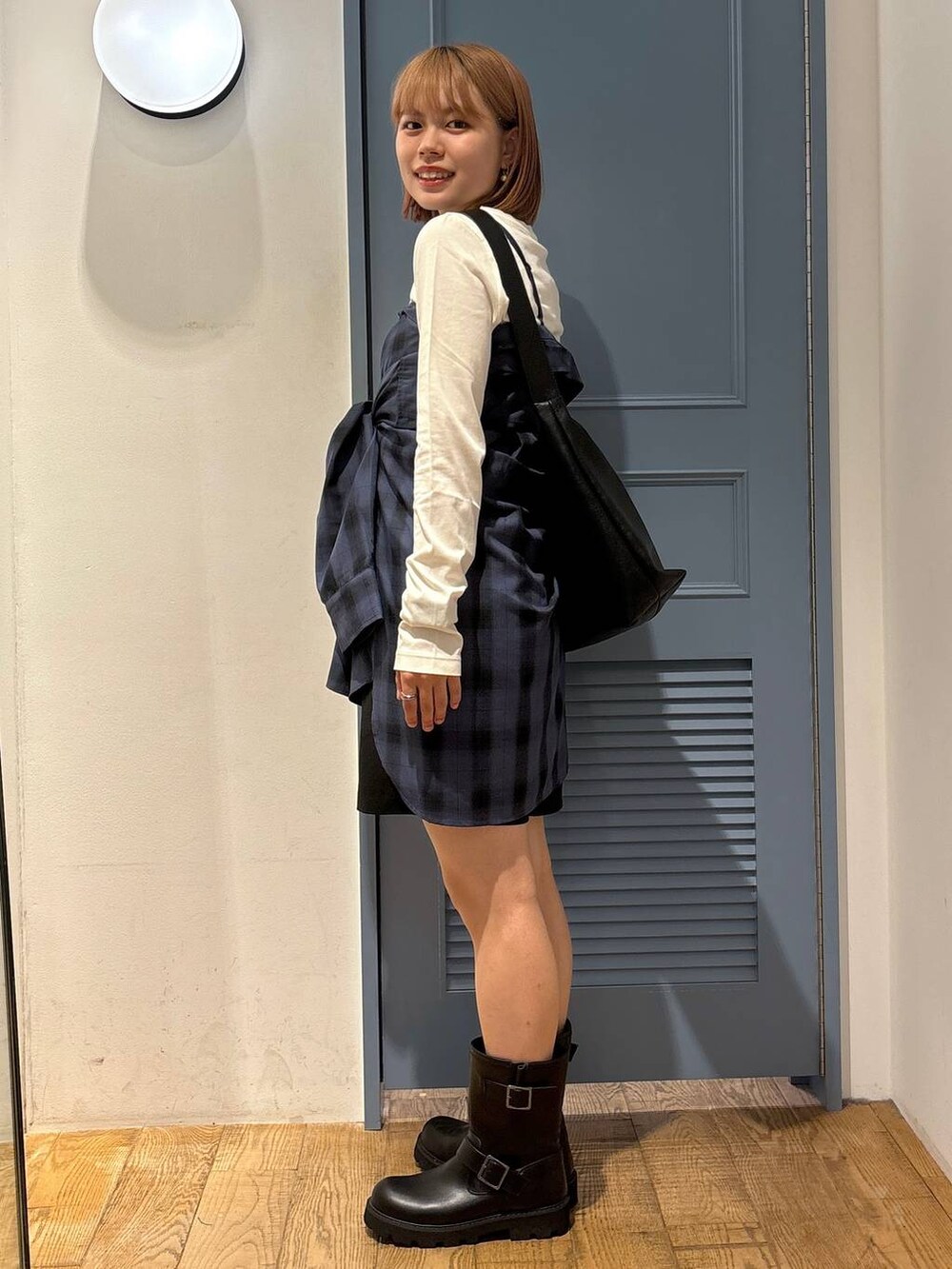 ブルー系のシャツ/ブラウス、ブラック系のボディバッグ/ウエストポーチ、ブラック系のブーツを着用したレディースの夏コーディネートの2枚目の写真