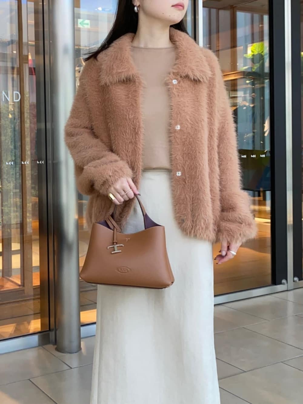 ブラウン系のブーツ、ベージュ系のスカート、ベージュ系のカーディガン/ボレロを着用したレディースの秋コーディネートの5枚目の写真