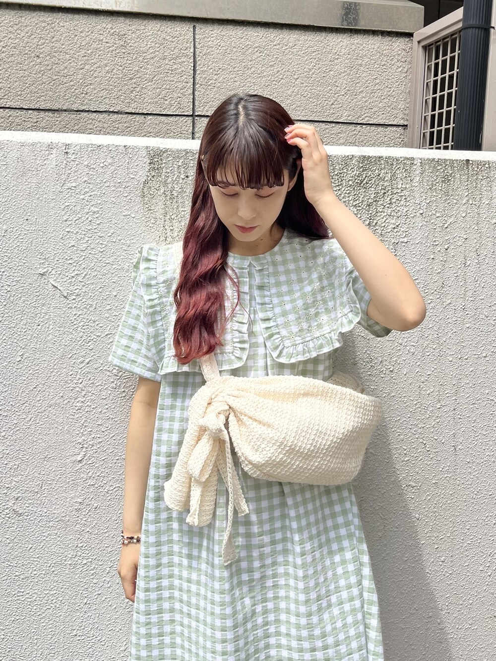 ホワイト系のショルダーバッグ、グリーン系のワンピース、ホワイト系のサンダルを着用したレディースの春コーディネートの3枚目の写真