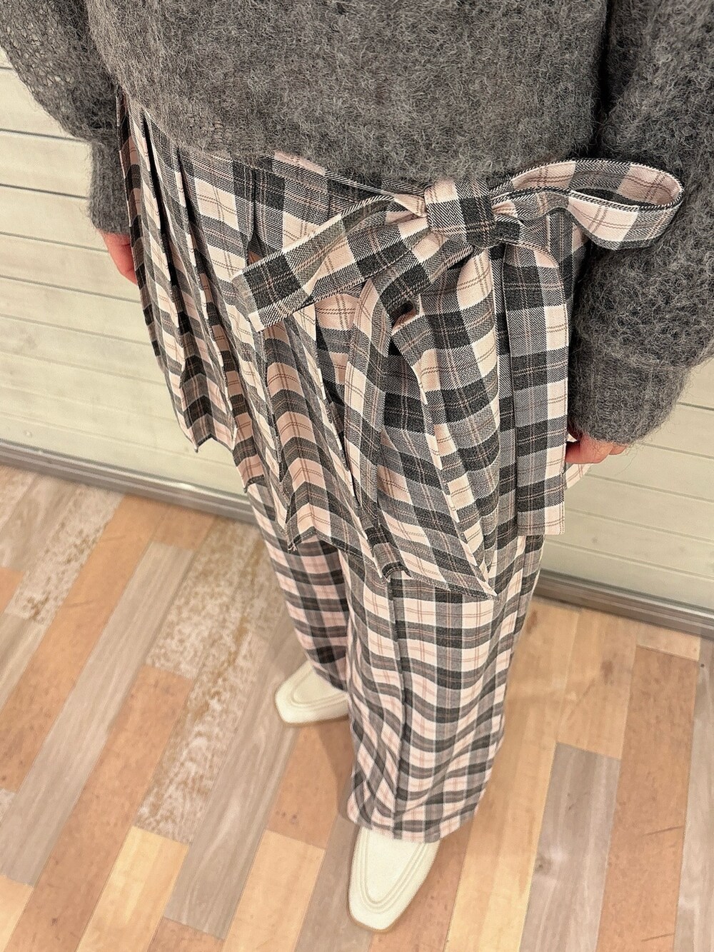 グレー系のニット/セーター、ブラック系のTシャツ/カットソー、ピンク系のスラックスを着用したレディースの秋コーディネートの6枚目の写真