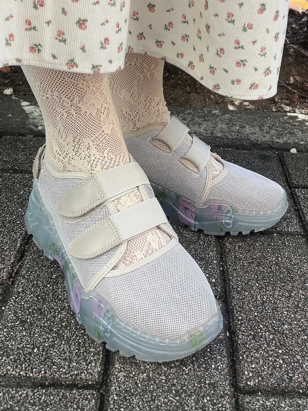 ピンク系のTシャツ/カットソー、ホワイト系のジャンパースカート、ベージュ系のスニーカーを着用したレディースの秋コーディネートの6枚目の写真