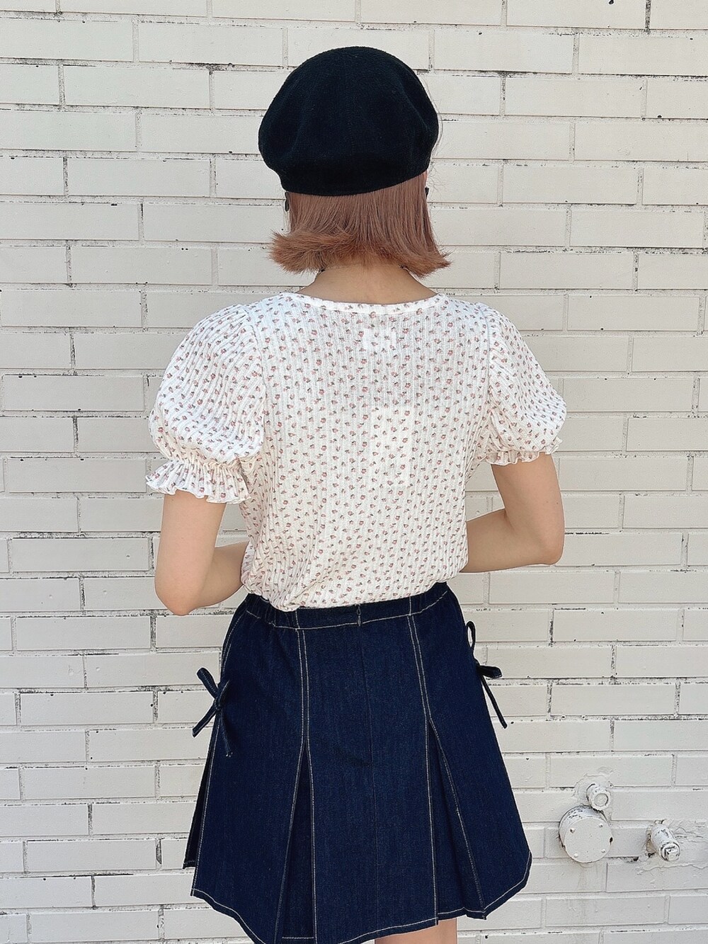 ブルー系のスカート、ブラック系のサンダル、ピンク系のTシャツ/カットソーを着用したレディースの春コーディネートの4枚目の写真