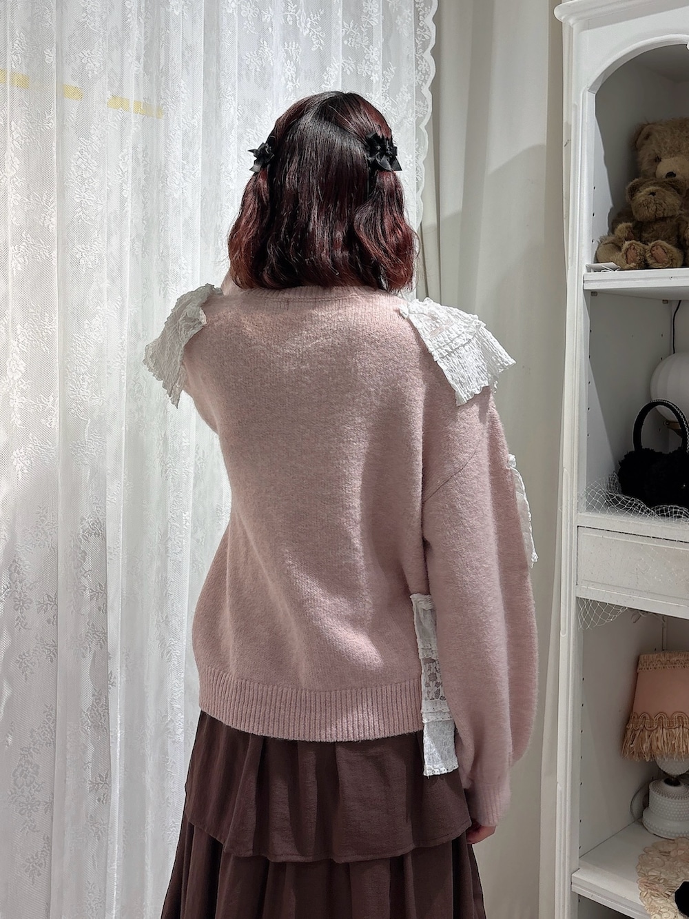 ピンク系のニット/セーター、ホワイト系のショルダーバッグ、ブラウン系のスカートを着用したレディースの秋コーディネートの4枚目の写真