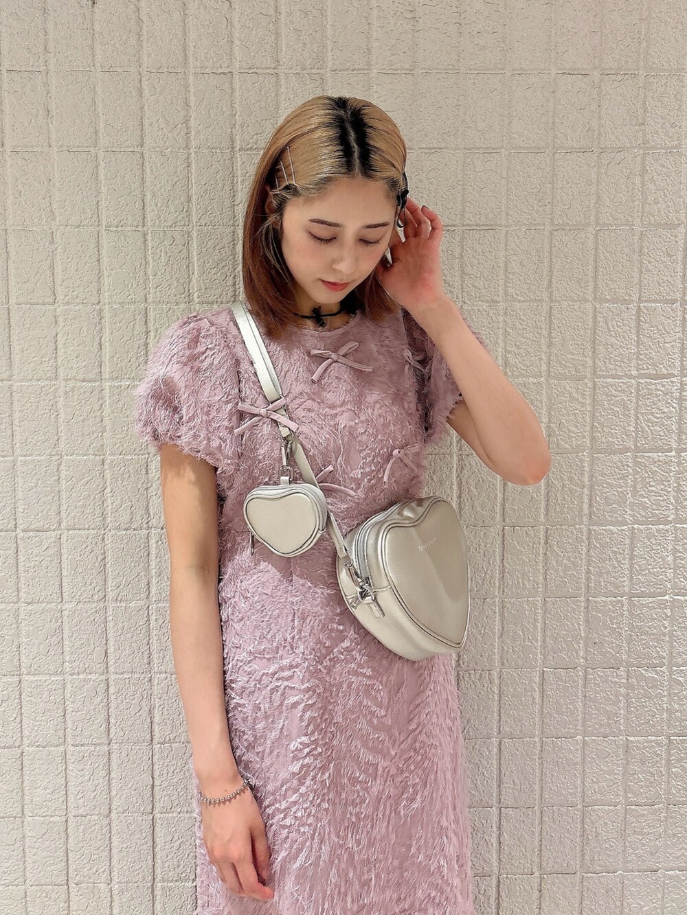ピンク系のワンピース、ゴールド系のショルダーバッグ、ブラック系のスニーカーを着用したレディースの夏コーディネートの3枚目の写真