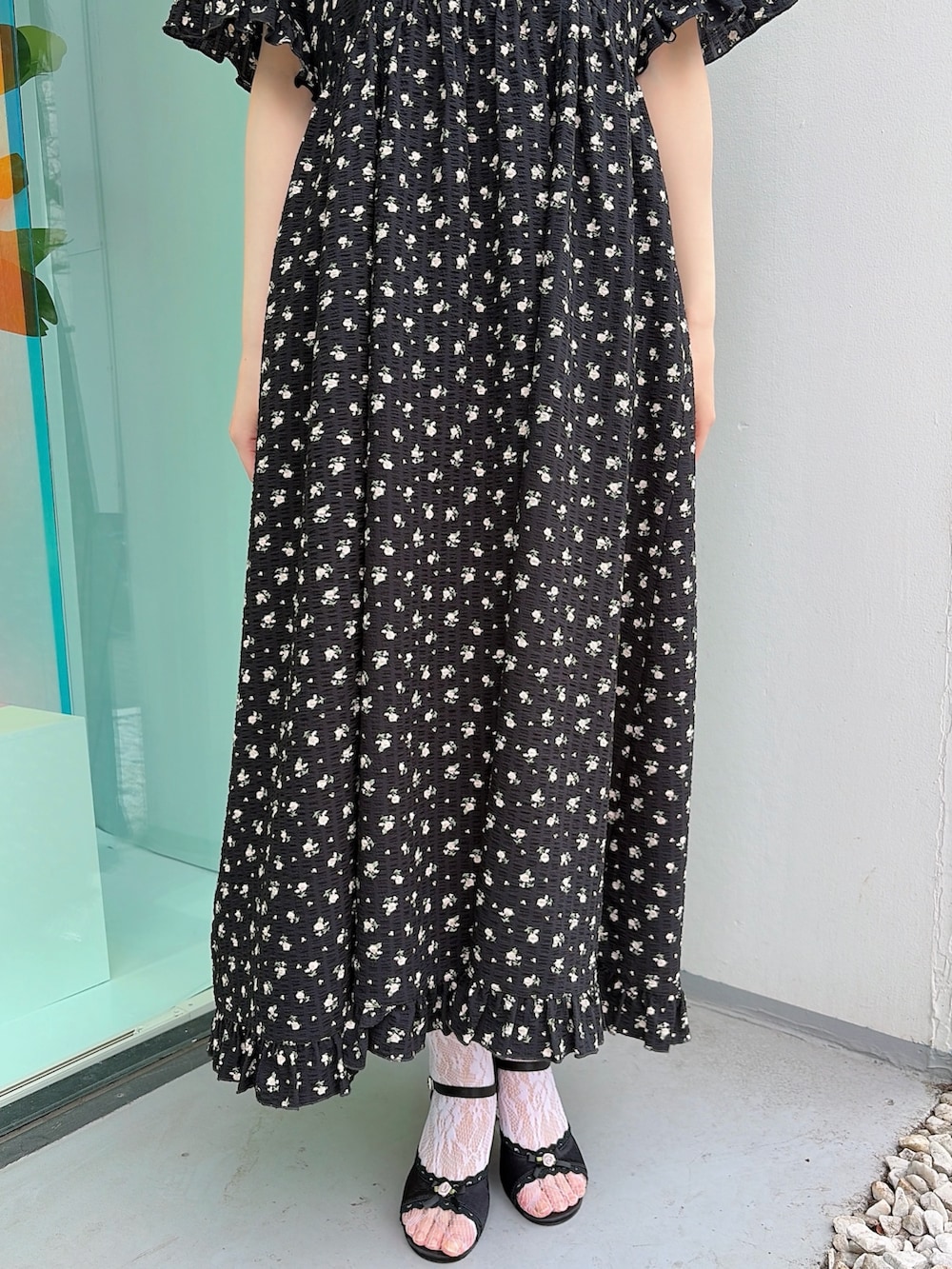 ブラック系のワンピース、ブラック系のサンダルを着用したレディースの春コーディネートの6枚目の写真