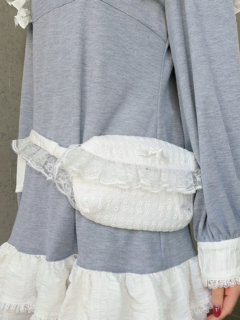 グレー系のワンピース、ブラック系のスニーカー、ホワイト系のボディバッグ/ウエストポーチを着用したレディースの冬コーディネートの5枚目の写真