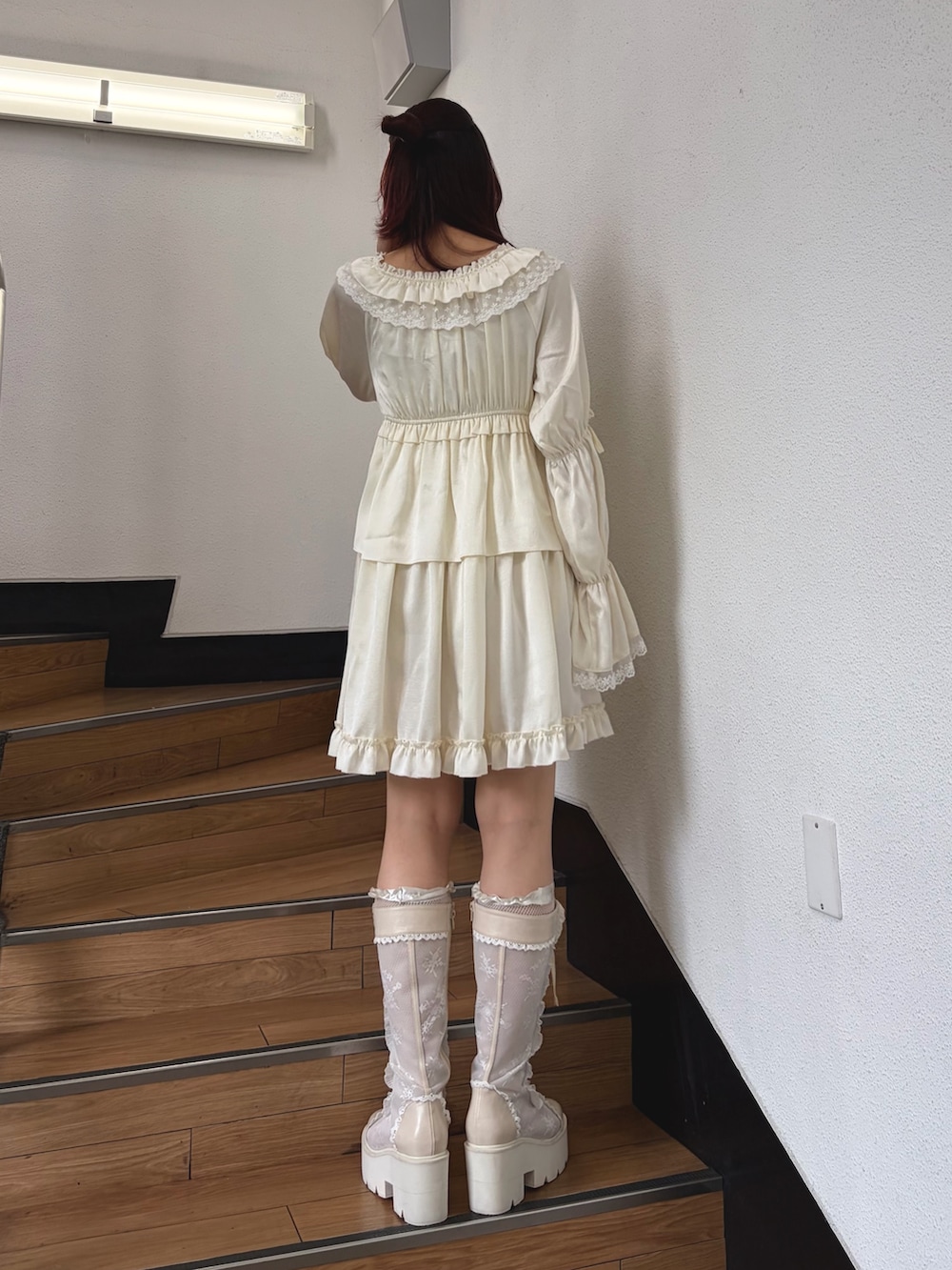 ホワイト系のワンピース、ホワイト系のブーツを着用したレディースの夏コーディネートの2枚目の写真