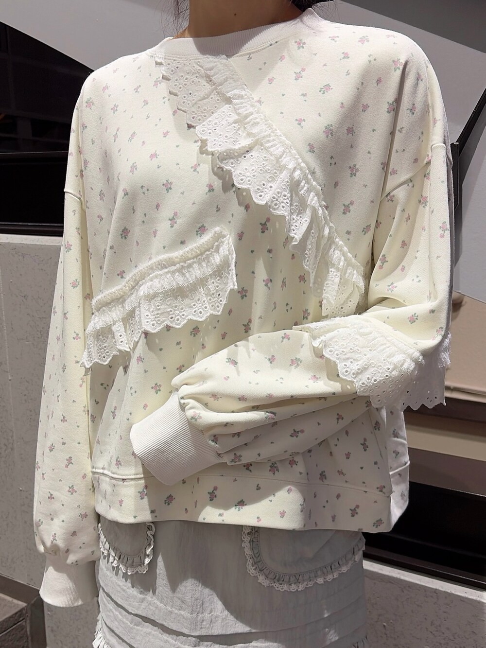 ホワイト系のスウェット、ブルー系のスカート、ブラック系のスニーカーを着用したレディースの冬コーディネートの5枚目の写真