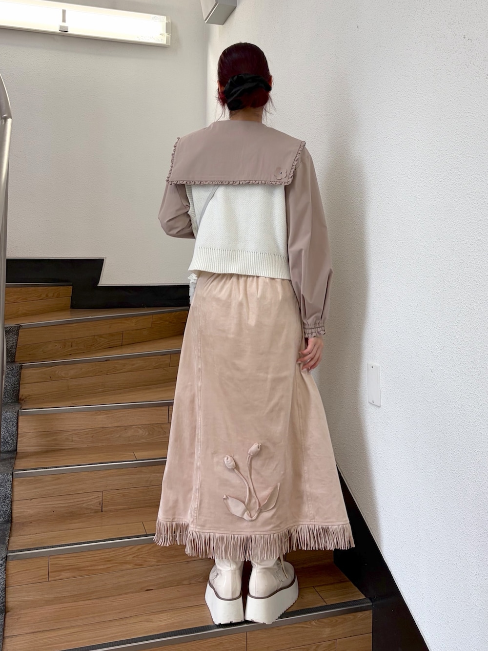 ベージュ系のシャツ/ブラウス、ホワイト系のベスト、ブルー系のハンドバッグを着用したレディースの夏コーディネートの2枚目の写真