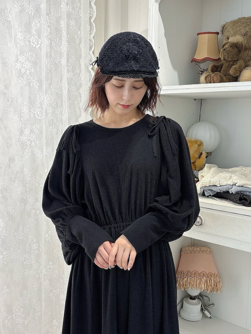 ブラック系のワンピース、ブラウン系のスニーカー、ブラック系のキャップを着用したレディースの秋コーディネートの3枚目の写真