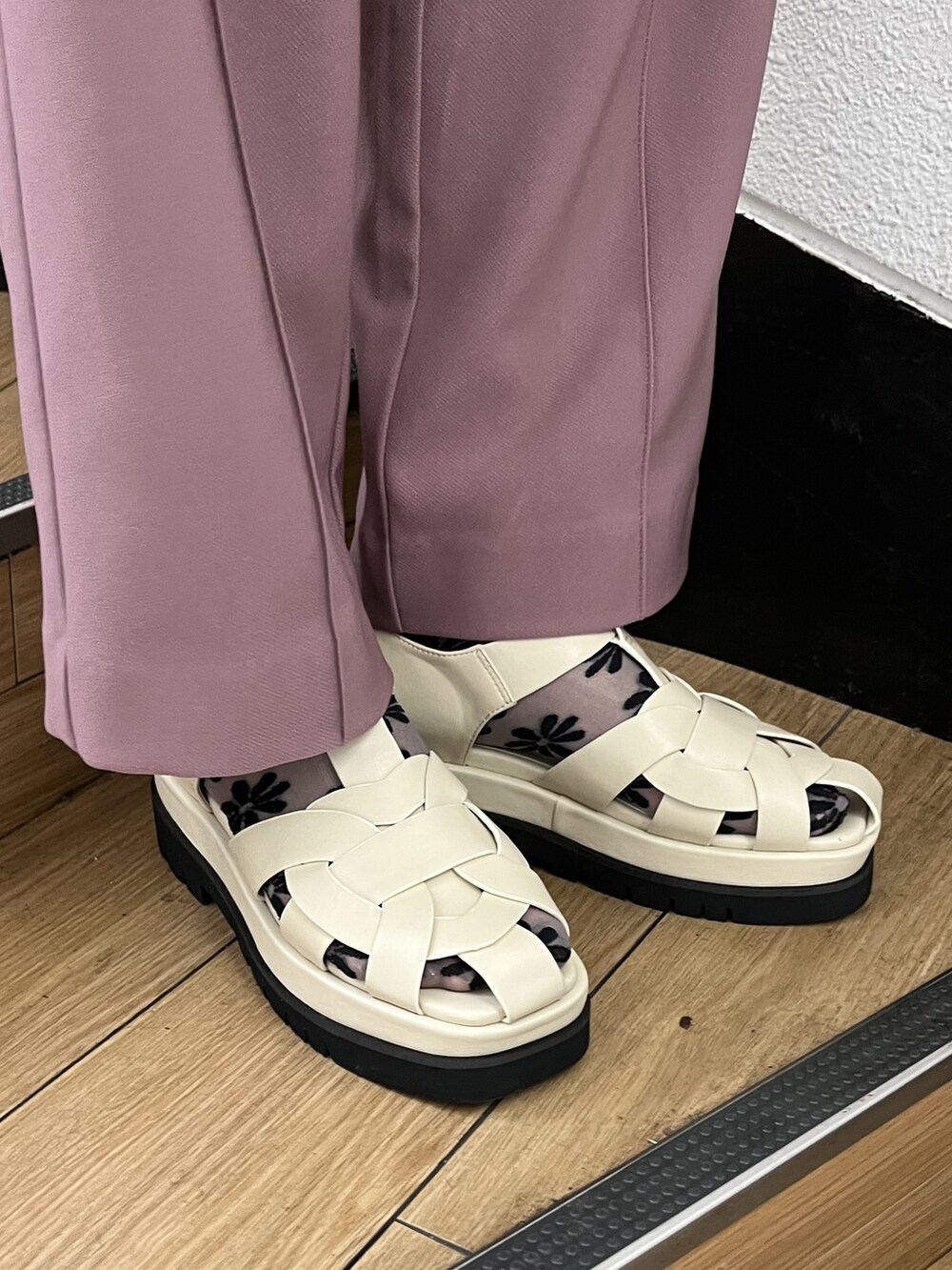 ホワイト系のハンドバッグ、ピンク系のスラックス、ホワイト系のサンダルを着用したレディースの夏コーディネートの3枚目の写真