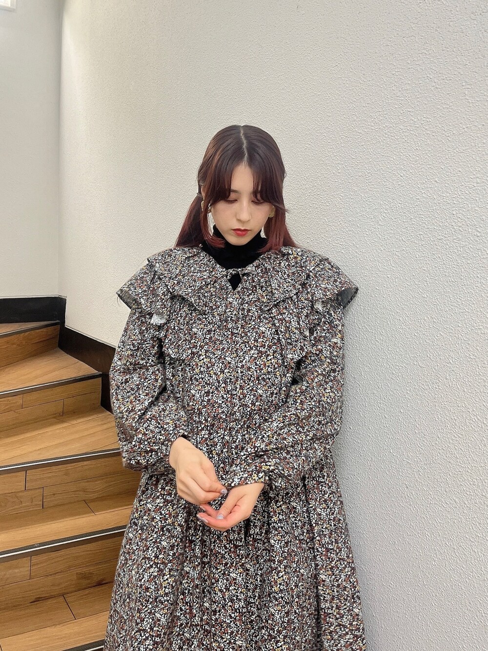 ブラウン系のワンピース、ホワイト系のスニーカー、ブラック系のニット/セーターを着用したレディースの秋コーディネートの2枚目の写真