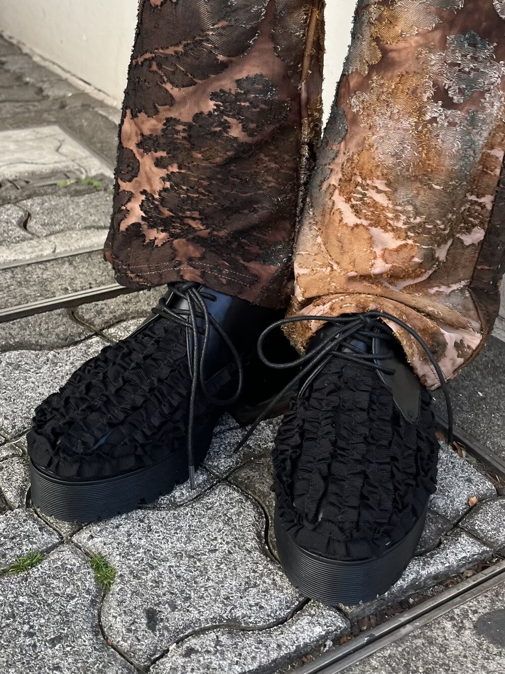 ブラウン系のその他パンツ、ブラック系のその他シューズ、グレー系のTシャツ/カットソーを着用したレディースの冬コーディネートの3枚目の写真