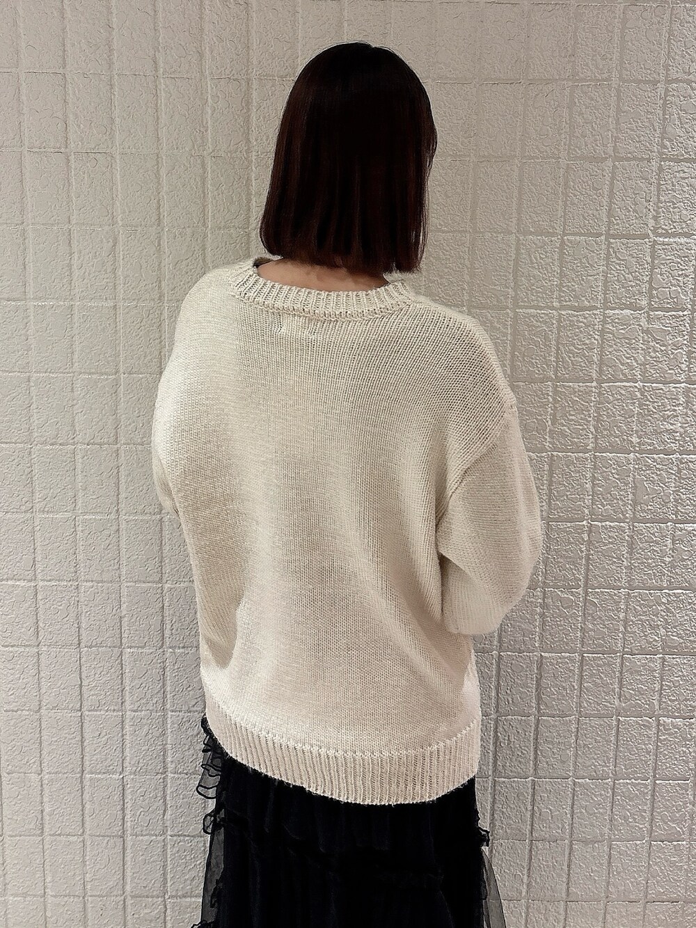 ピンク系のブルゾン、ホワイト系のニット/セーター、ブラック系のスカートを着用したレディースの冬コーディネートの7枚目の写真