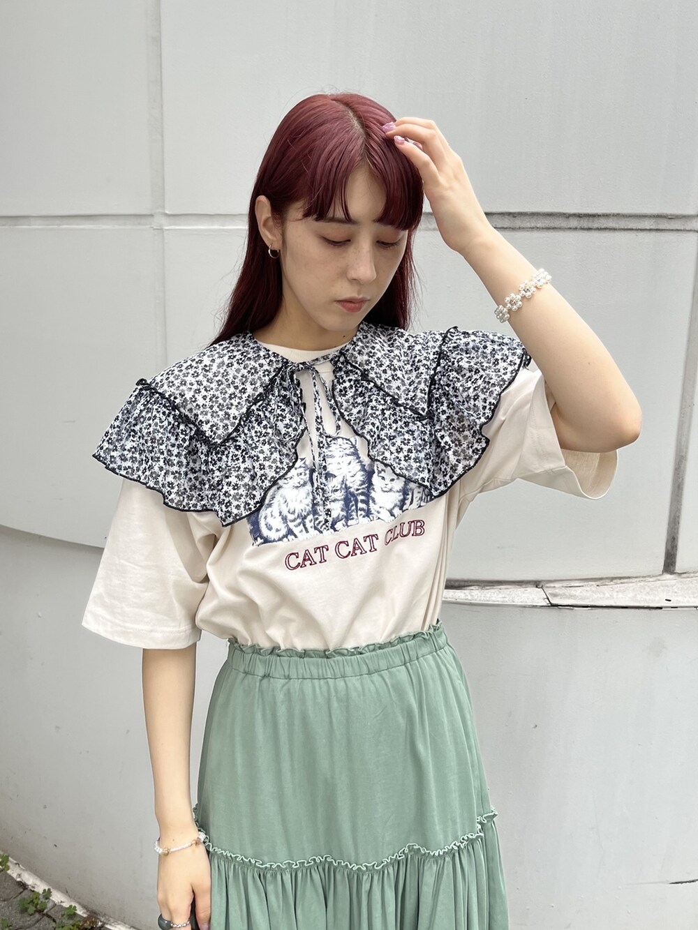 ホワイト系のトートバッグ、レッド系のサンダル、グリーン系のスカートを着用したレディースの春コーディネートの3枚目の写真