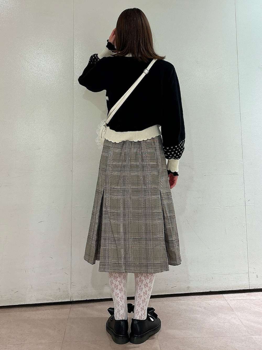 ブラック系のカーディガン/ボレロ、ブラック系のTシャツ/カットソー、ホワイト系のショルダーバッグを着用したレディースの秋コーディネートの2枚目の写真