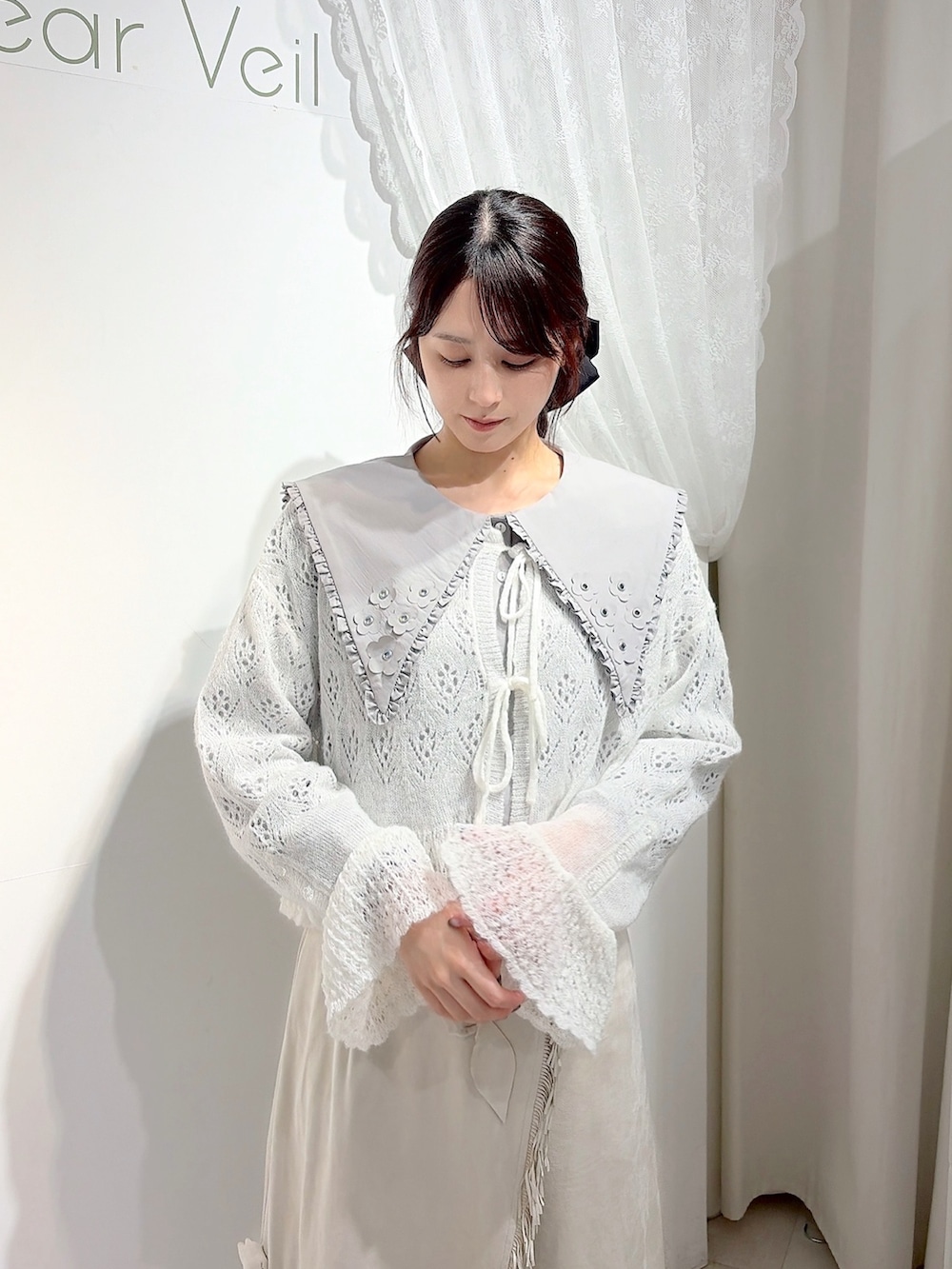 グレー系のシャツ/ブラウス、ホワイト系のカーディガン/ボレロ、ホワイト系のスカートを着用したレディースの秋コーディネートの4枚目の写真