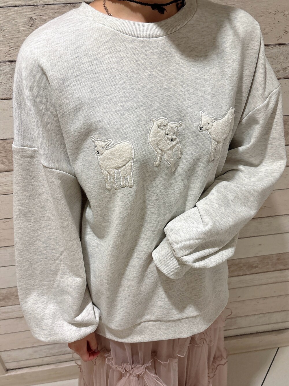 ピンク系のスカート、グレー系のスウェット、ホワイト系のスニーカーを着用したレディースの秋コーディネートの5枚目の写真