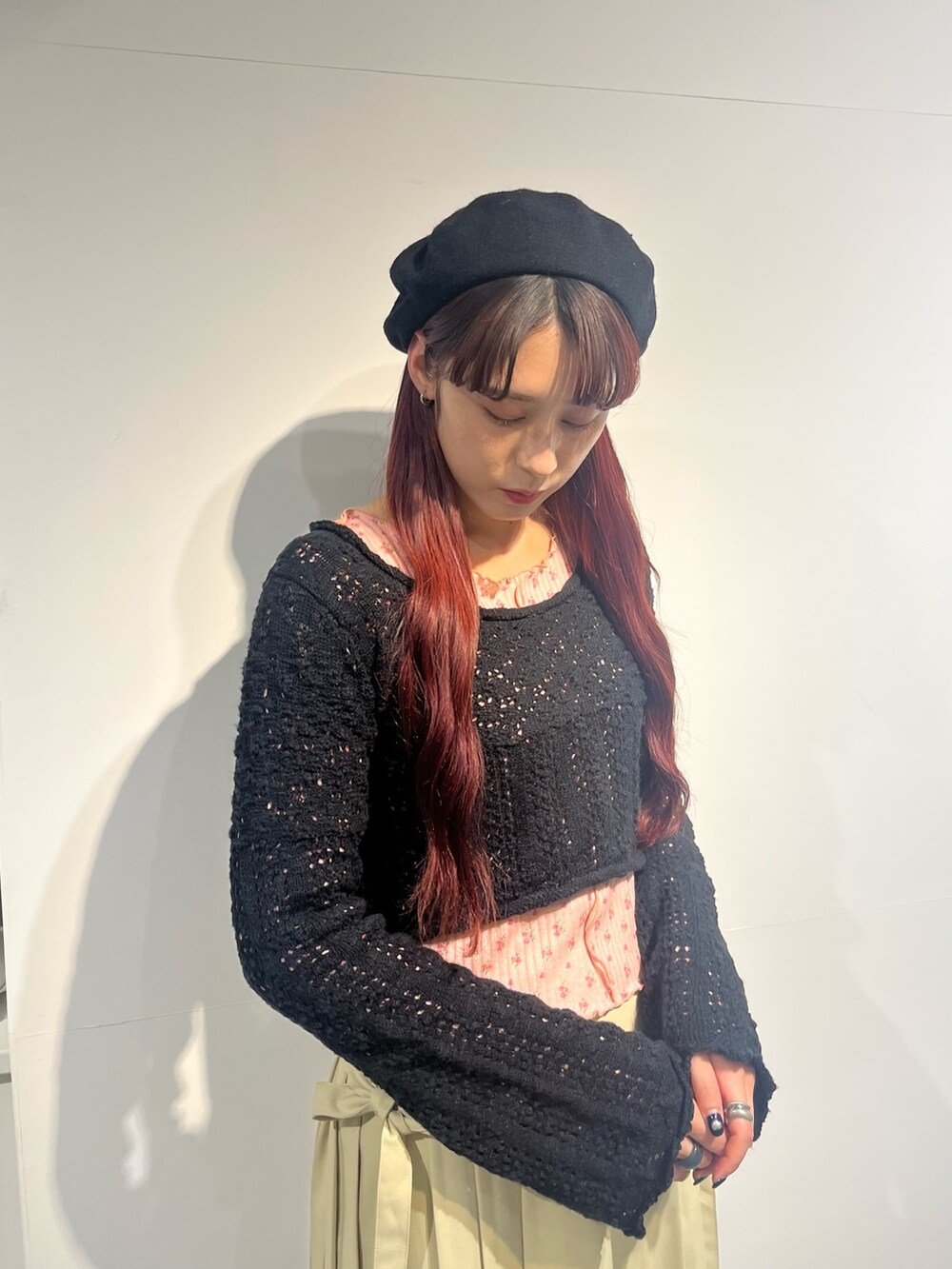 ブラック系のパンプス、ピンク系のTシャツ/カットソー、ブラック系のニット/セーターを着用したレディースの冬コーディネートの2枚目の写真