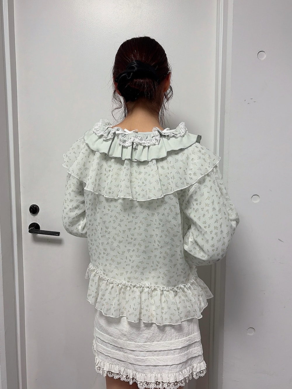 グリーン系のTシャツ/カットソー、ブルー系のカーディガン/ボレロ、ホワイト系のスカートを着用したレディースの冬コーディネートの4枚目の写真