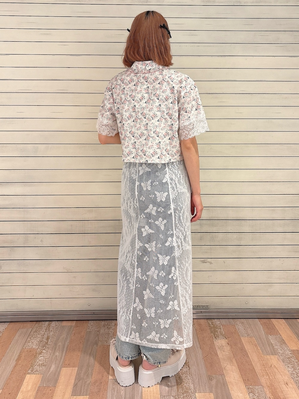 ピンク系のシャツ/ブラウス、ホワイト系のスカート、ブルー系のデニムパンツを着用したレディースの春コーディネートの2枚目の写真