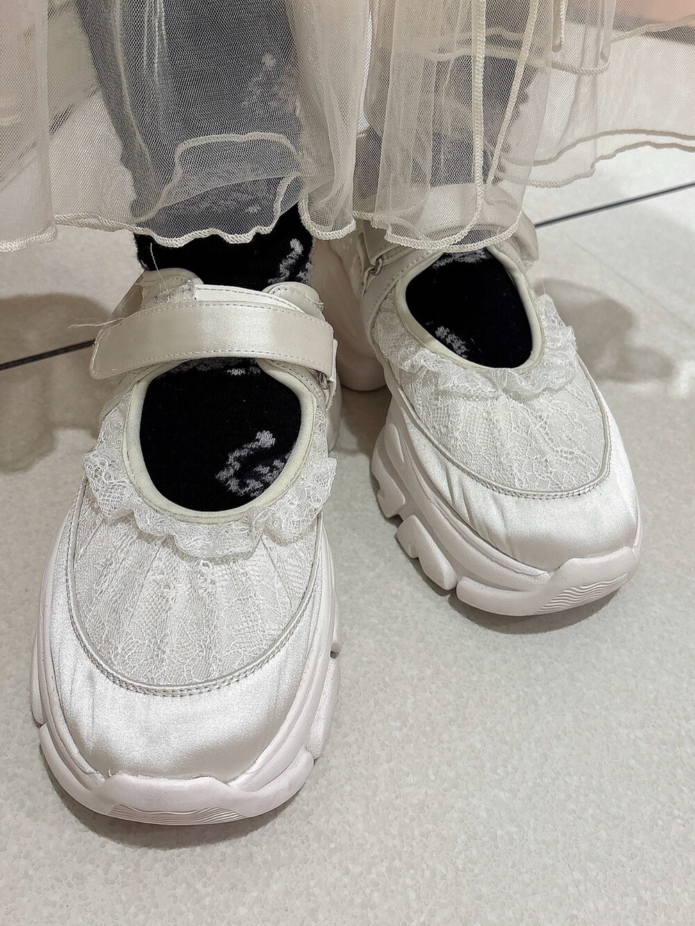 ブラック系のシャツ/ブラウス、グレー系のスウェット、ホワイト系のスカートを着用したレディースの冬コーディネートの5枚目の写真