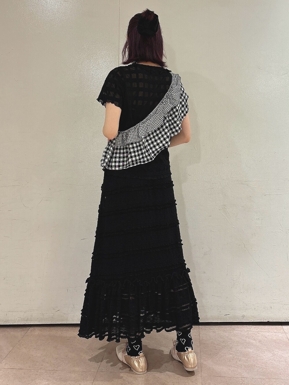 ブラック系のスカート、ブラック系のTシャツ/カットソー、ゴールド系のバレエシューズを着用したレディースの春コーディネートの2枚目の写真