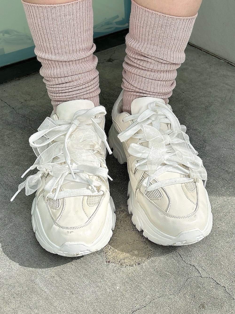 ホワイト系のスウェット、ブラック系のスカート、ホワイト系のスニーカーを着用したレディースの冬コーディネートの4枚目の写真