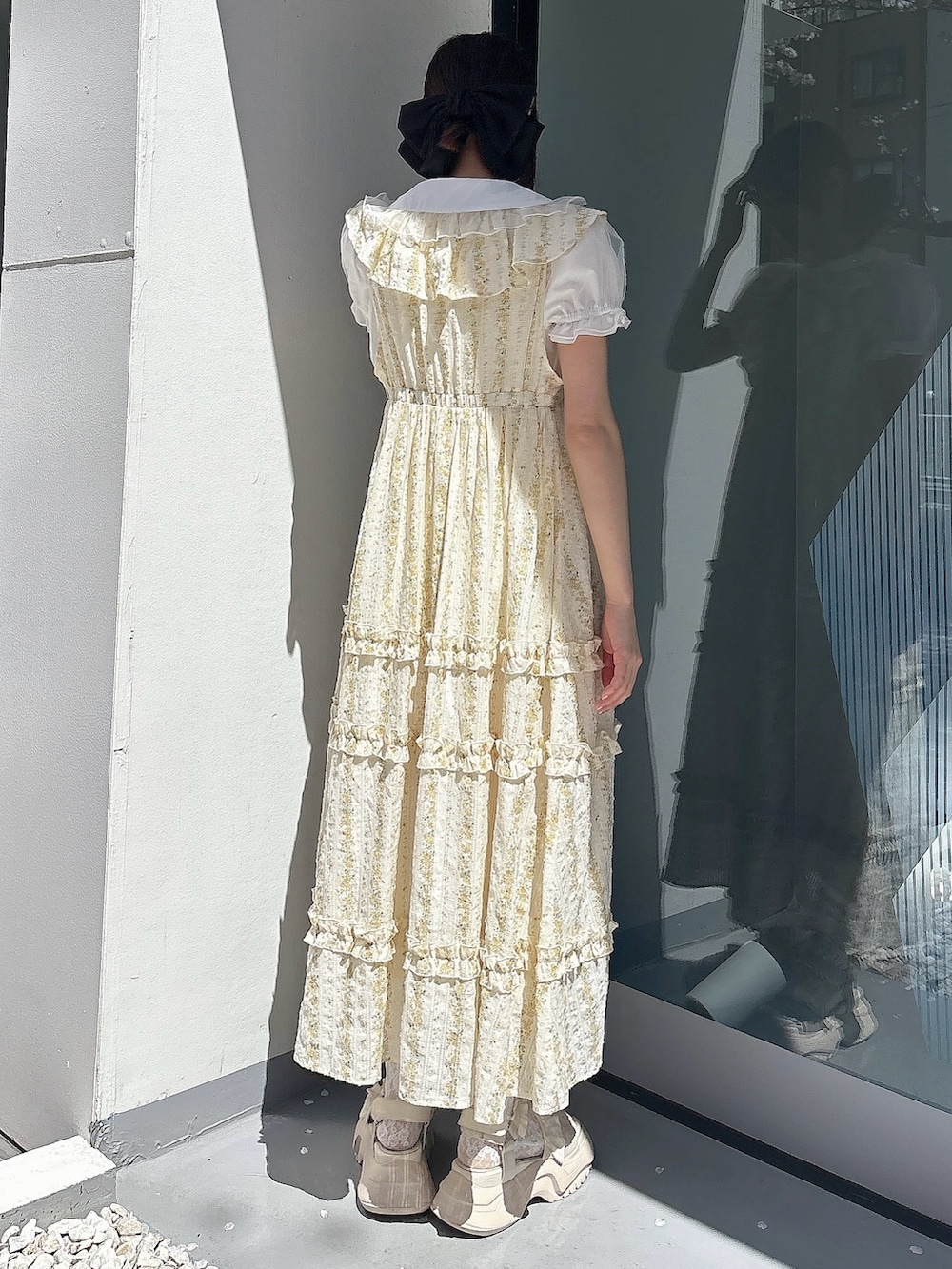 ホワイト系のシャツ/ブラウス、イエロー系のワンピース、ホワイト系のサンダルを着用したレディースの春コーディネートの2枚目の写真