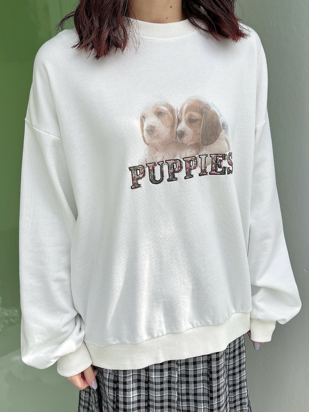 ホワイト系のスウェット、ブラック系のスカート、ホワイト系のスニーカーを着用したレディースの冬コーディネートの3枚目の写真