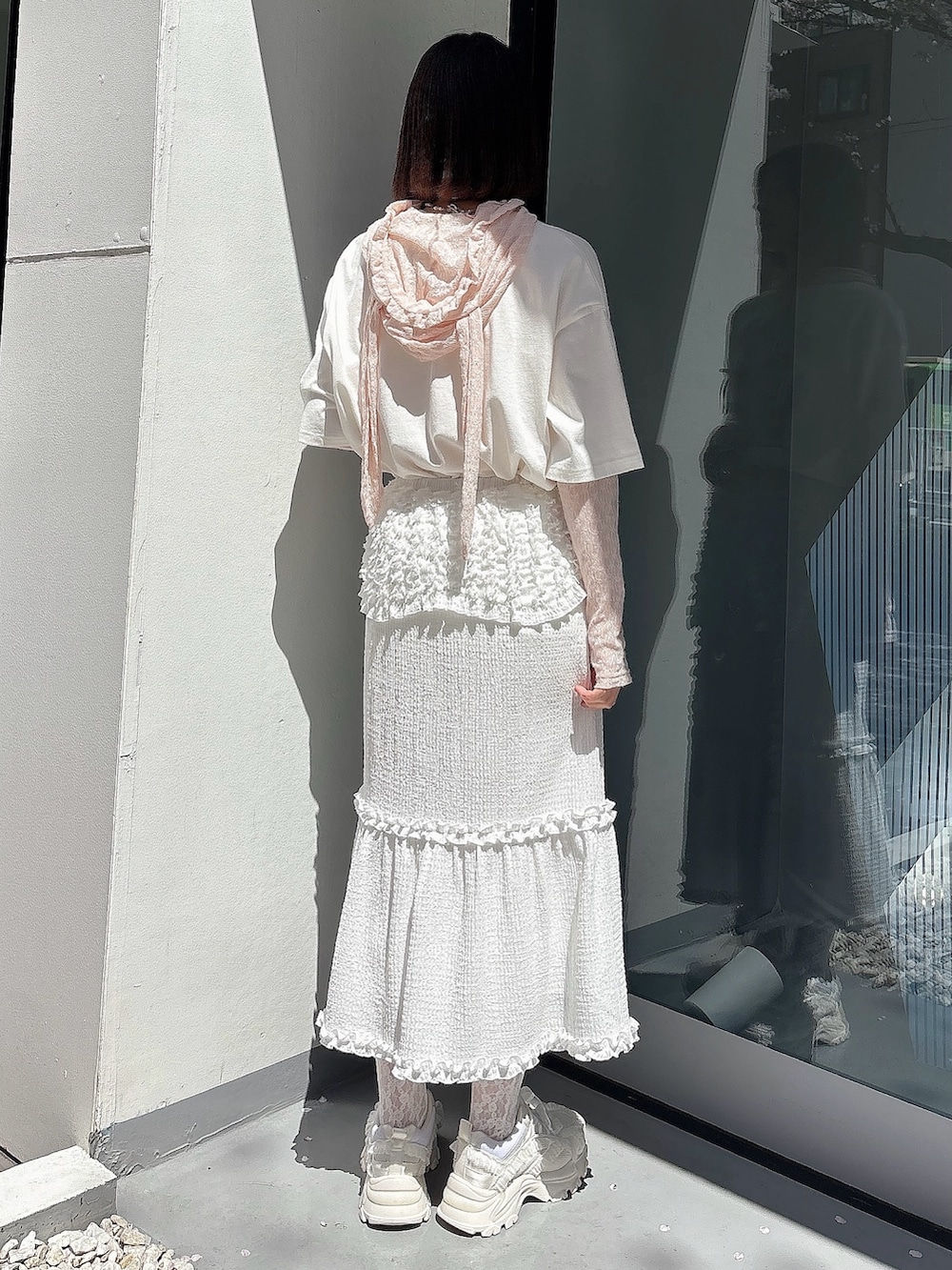 ピンク系のTシャツ/カットソー、ホワイト系のTシャツ/カットソー、ホワイト系のスカートを着用したレディースの春コーディネートの2枚目の写真