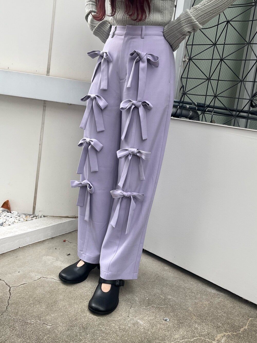 パープル系のその他パンツ、ブラック系のブーツ、グリーン系のニット/セーターを着用したレディースの冬コーディネートの3枚目の写真