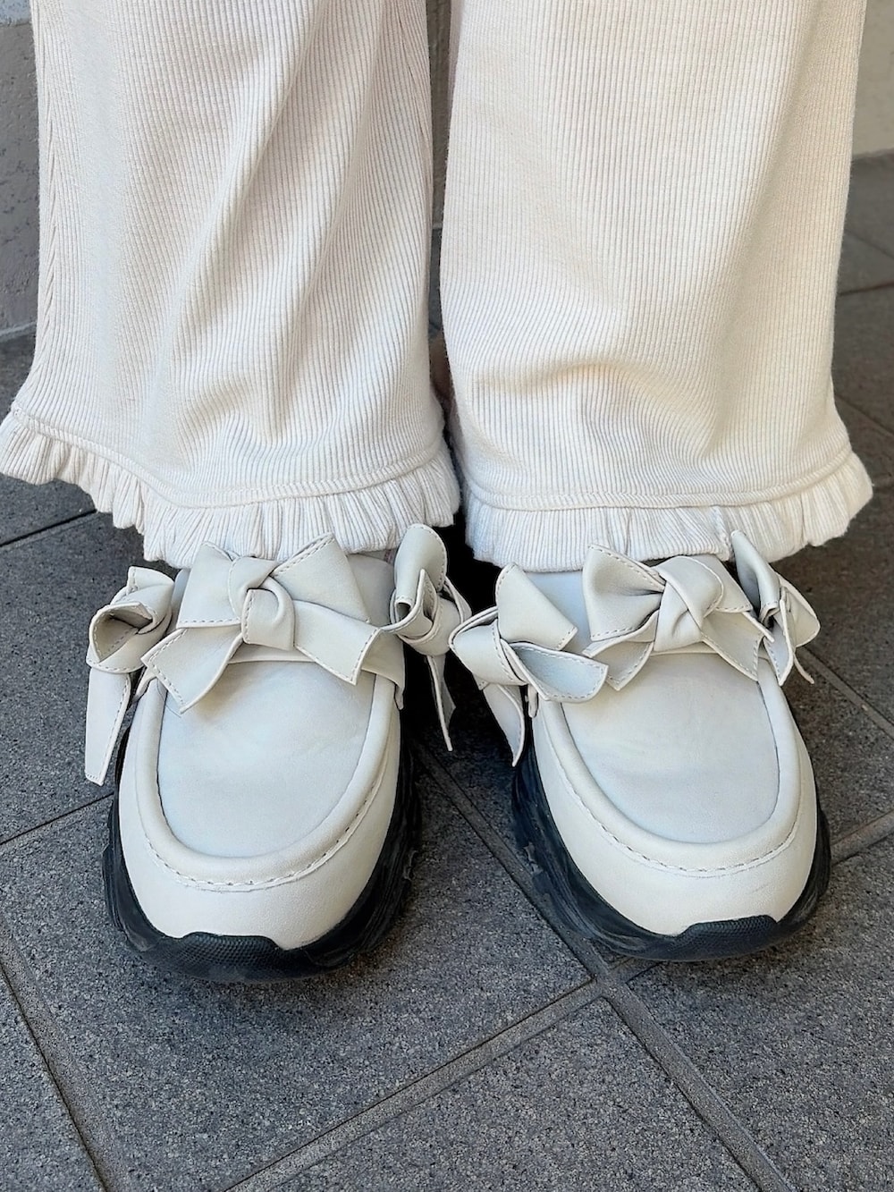 グレー系のスウェット、ホワイト系のショルダーバッグ、ホワイト系のスウェットパンツを着用したレディースの冬コーディネートの8枚目の写真