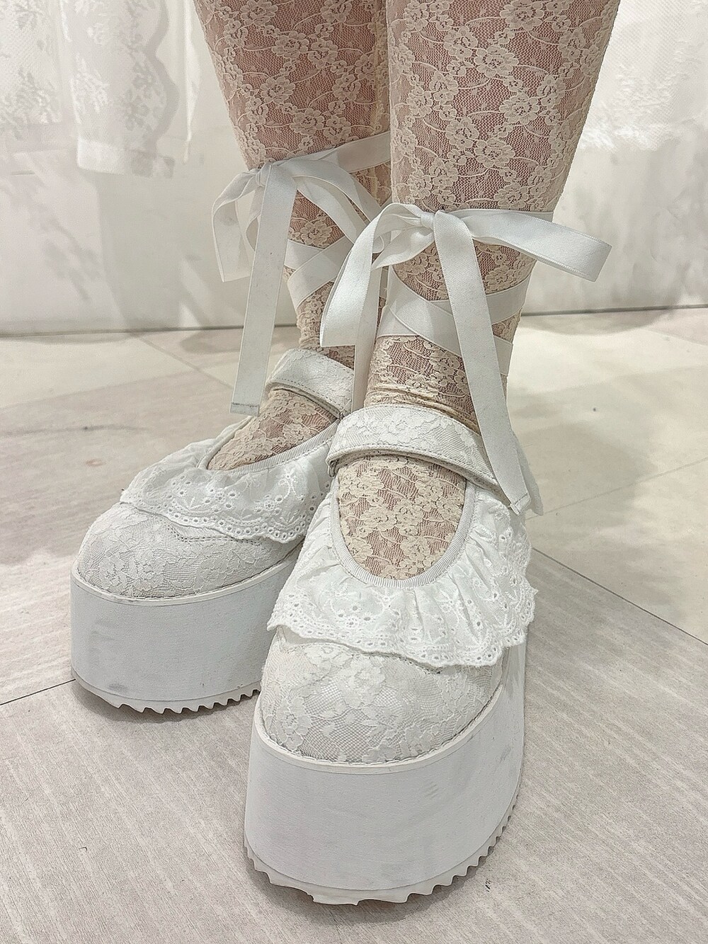 ブラウン系のスカート、ブラック系のショルダーバッグ、ホワイト系のスニーカーを着用したレディースの秋コーディネートの7枚目の写真