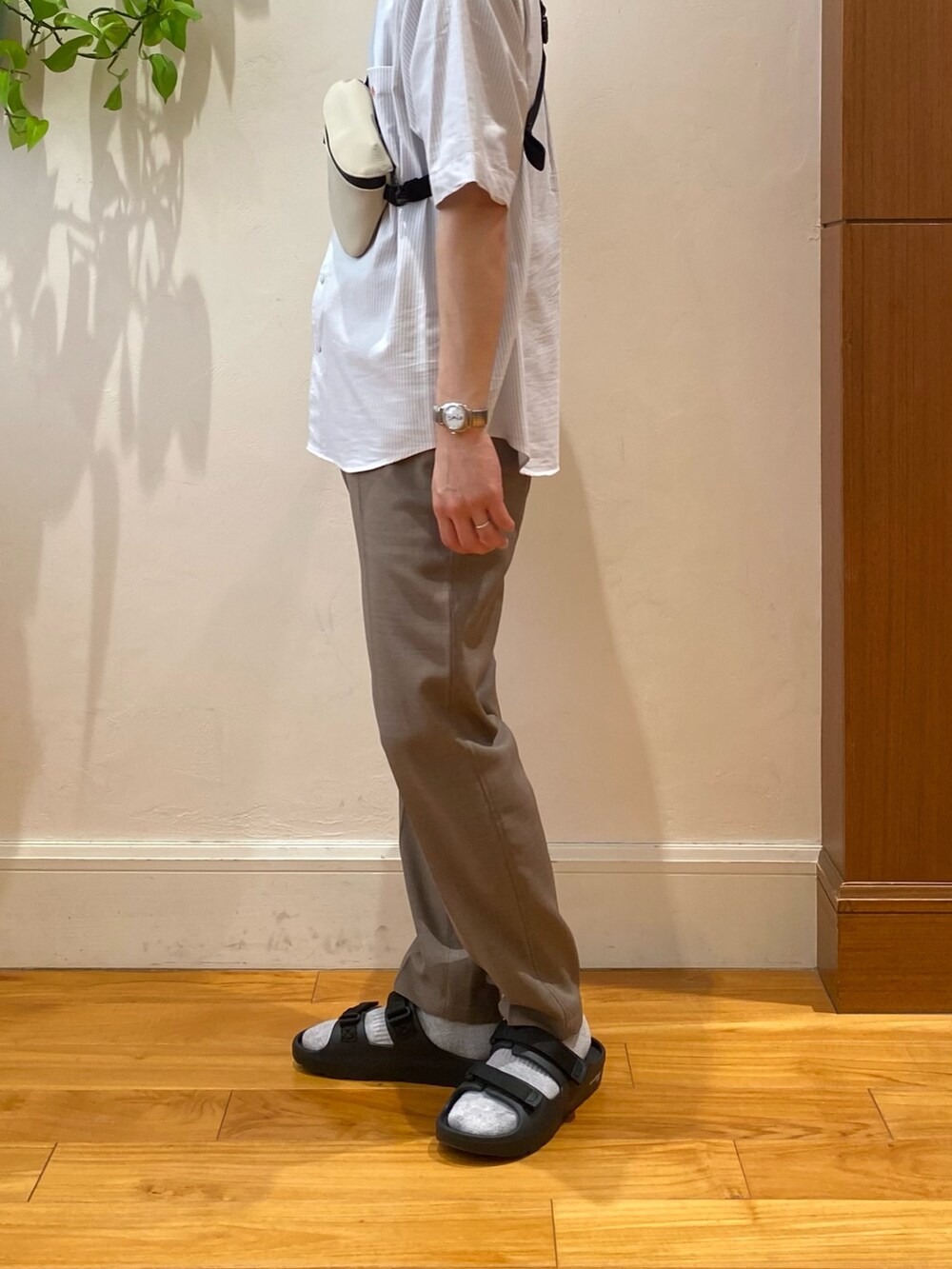 ホワイト系のシャツ/ブラウス、ベージュ系のショルダーバッグ、ブラック系のサンダルを着用したメンズの春コーディネートの2枚目の写真
