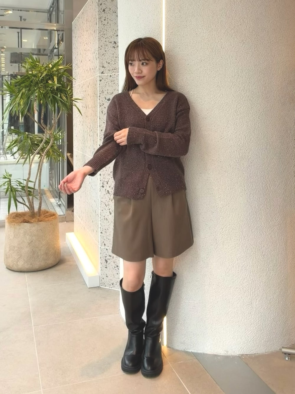 ブラウン系のカーディガン/ボレロ、ブラウン系のその他パンツ、ブラック系のブーツを着用したレディースの秋コーディネートの3枚目の写真