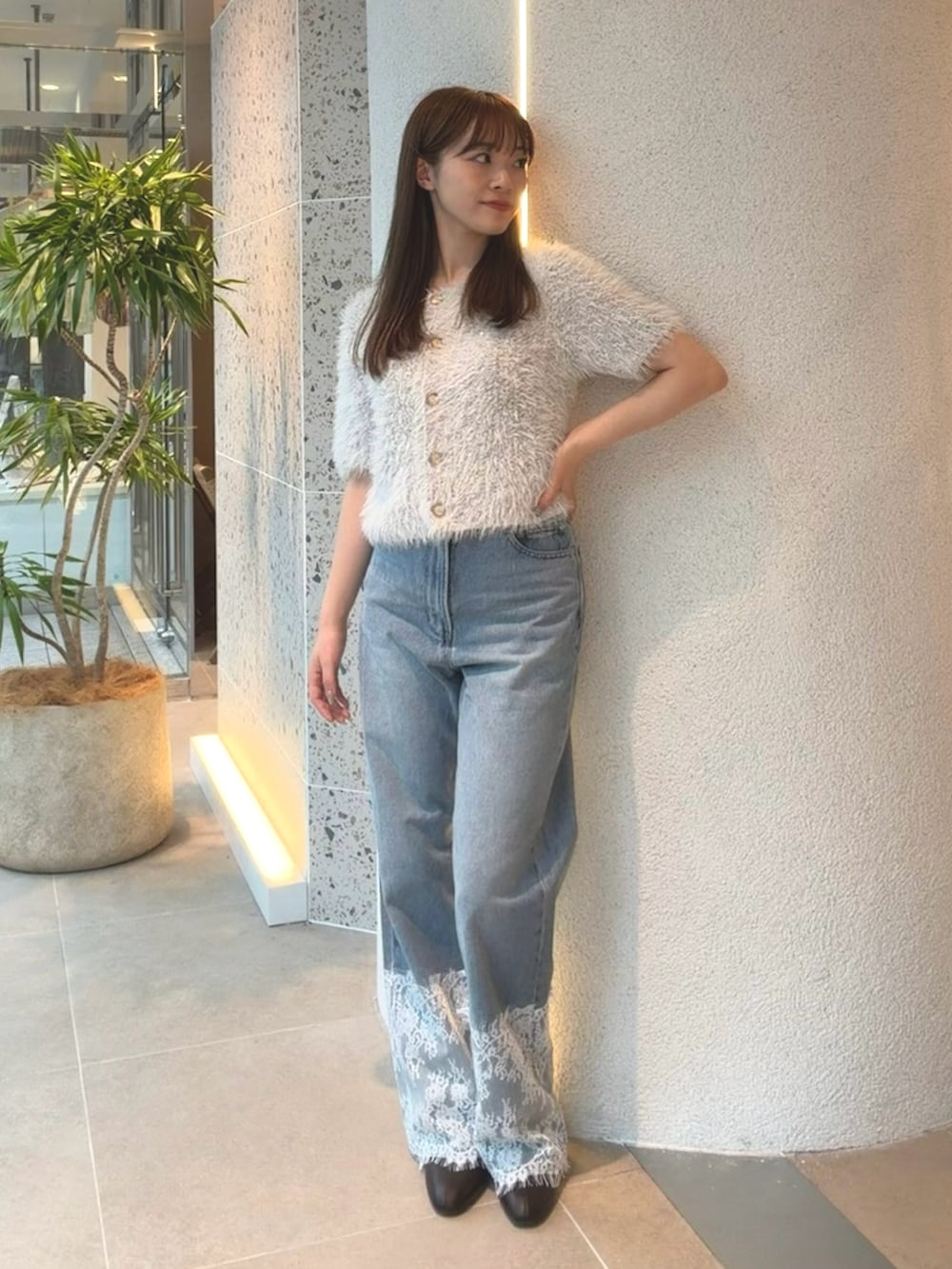 ブルー系のカーディガン/ボレロ、ブルー系のデニムパンツ、ブラウン系のブーツを着用したレディースの秋コーディネートの3枚目の写真