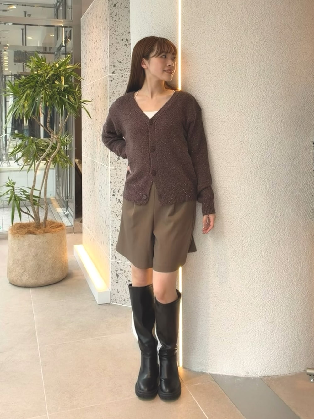 ブラウン系のカーディガン/ボレロ、ブラウン系のその他パンツ、ブラック系のブーツを着用したレディースの秋コーディネートの6枚目の写真