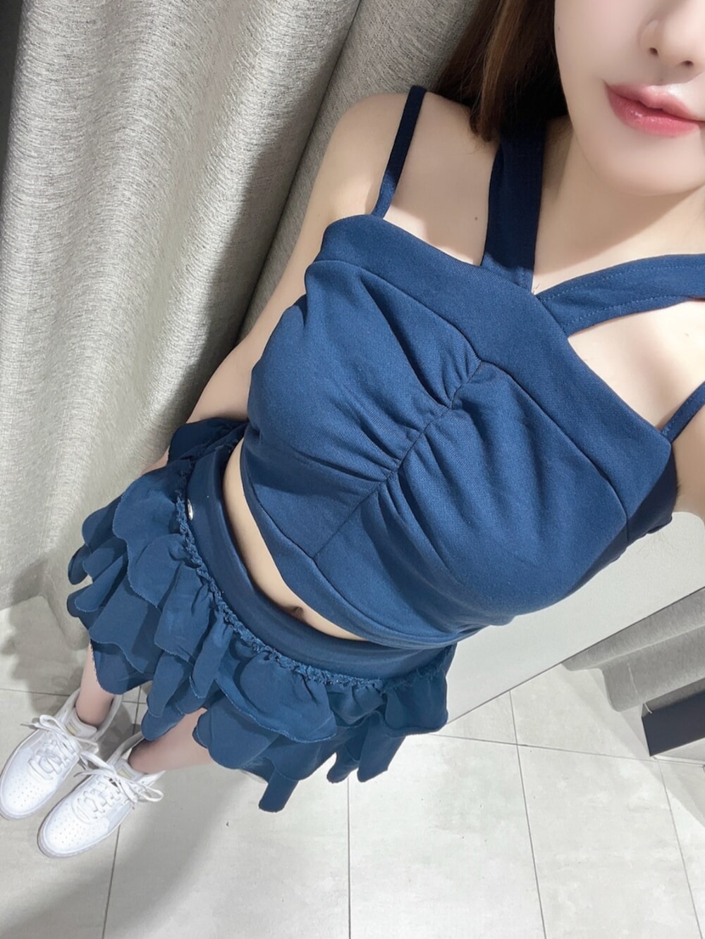 ホワイト系のスニーカー、ブルー系のキャミソール、ブルー系のスカートを着用したレディースの夏コーディネートの4枚目の写真