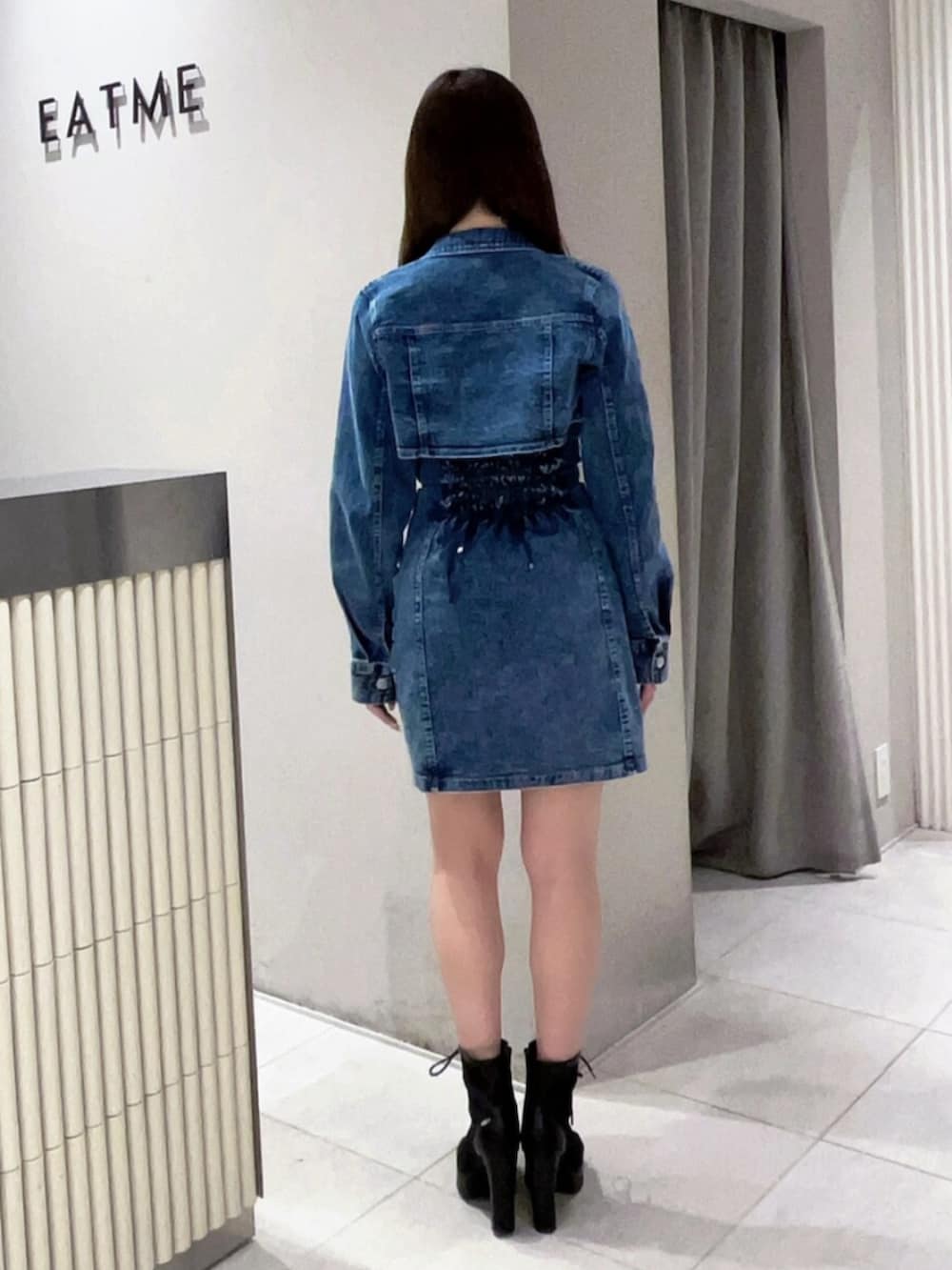 ブラック系のブーツ、ブルー系のワンピースを着用したレディースの春コーディネートの3枚目の写真