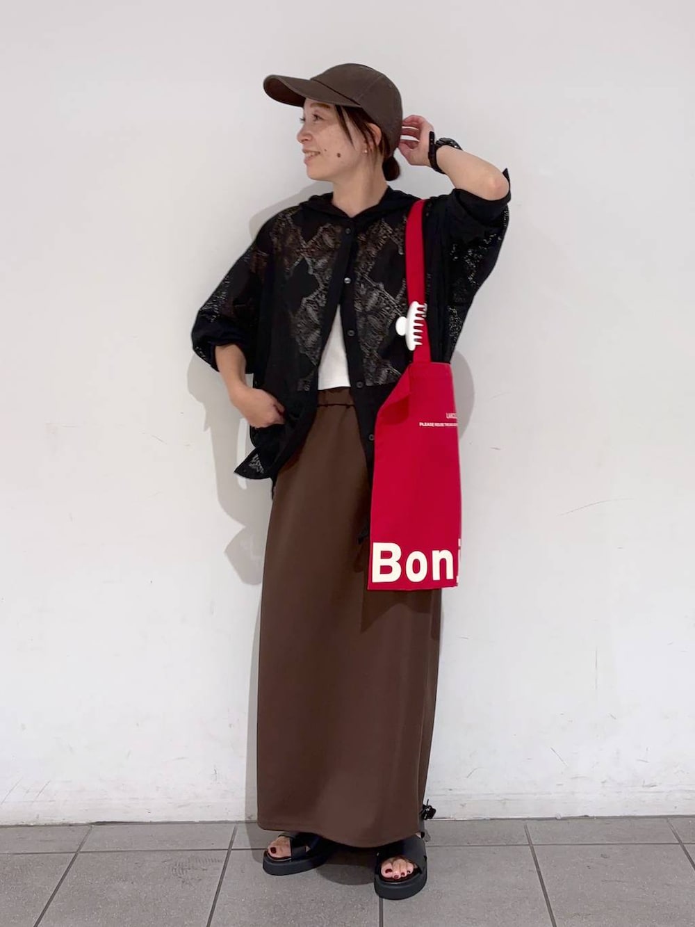 ブラック系のシャツ/ブラウス、ブラウン系のスカート、レッド系のトートバッグを着用したレディースの夏コーディネートの2枚目の写真